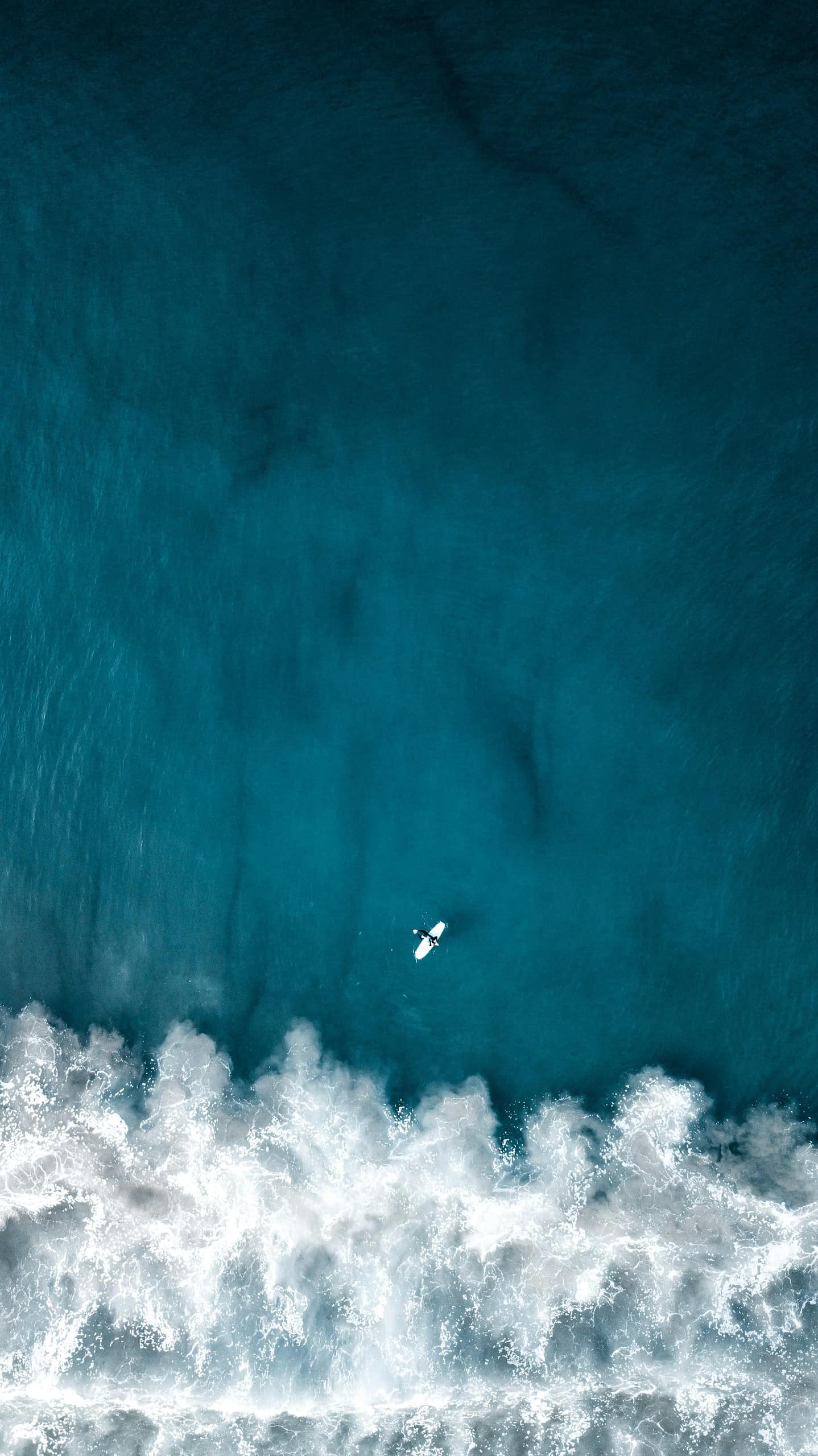 A surfer riding a wave, symbolizing navigating business challenges with AI solutions